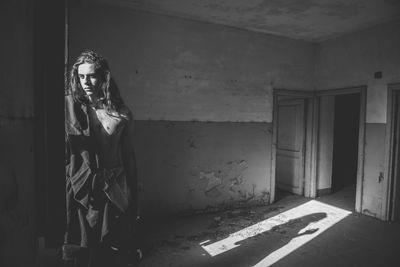 Shirtless man in abandoned room