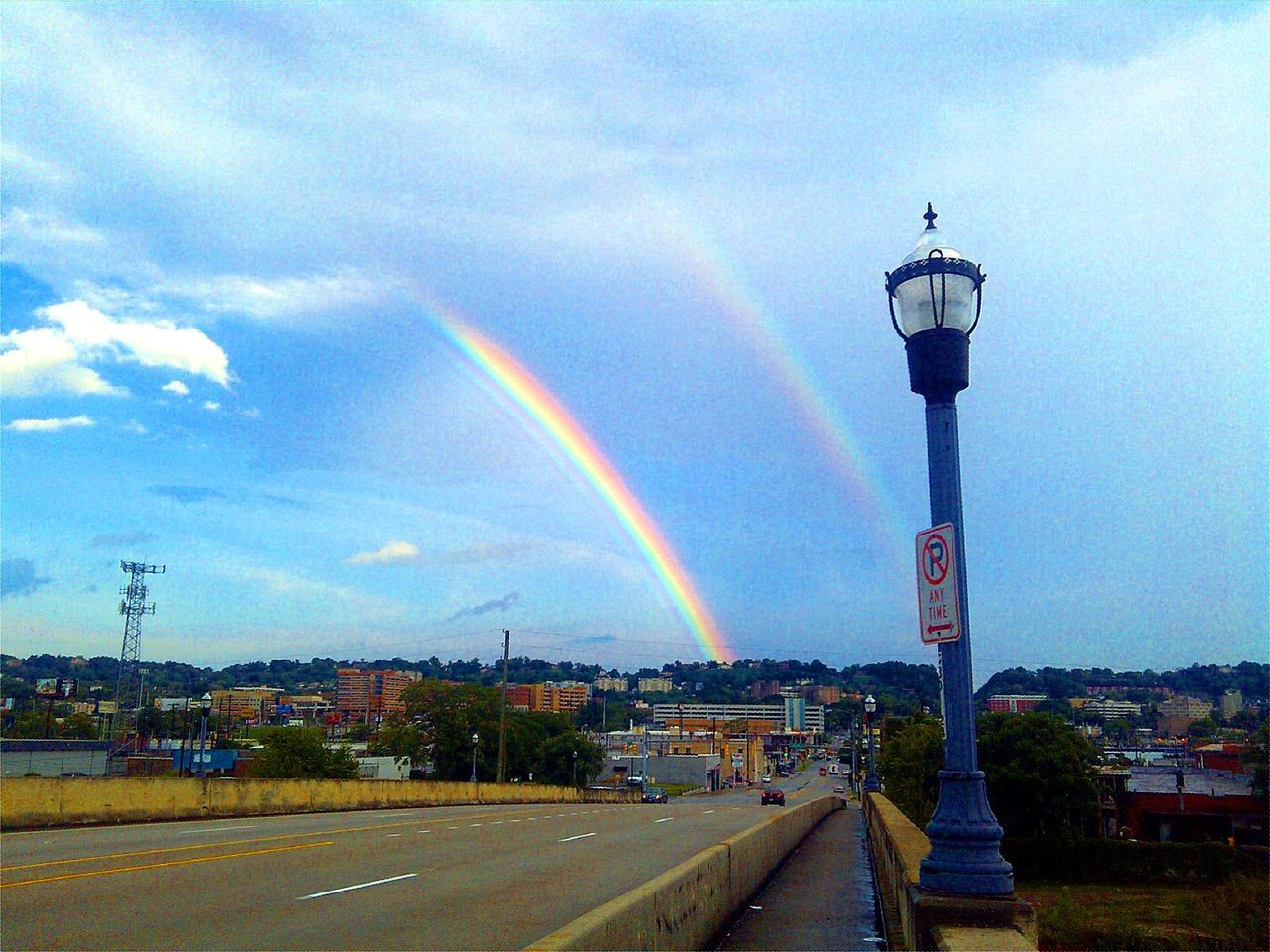 rainbow, multi colored, sky, building exterior, built structure, architecture, cloud, cloud - sky, beauty in nature, day, scenics, outdoors, tall - high, nature, arch, park, canal, town, tranquility, development, cloudy, tranquil scene