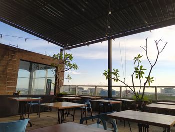 Empty chairs and tables in restaurant