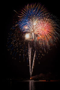 Low angle view of firework display at night