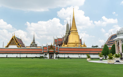 Temple by building against sky