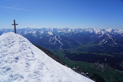 Scenic view of snowcapped mountains against clear blue sky