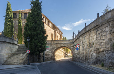 Steps and stone arched bridge with las duenas convent in the background