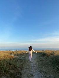 A girl running to the beach on a early morning 