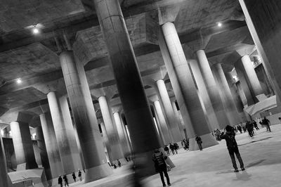 People walking in illuminated building