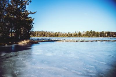 Scenic view of frozen lake against sky during winter