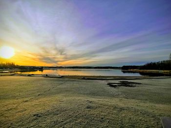 Scenic view of beach against sky during sunset