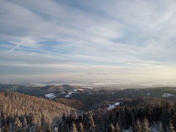 Scenic view of landscape against sky during winter