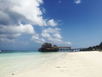 Surface level of calm beach against the sky