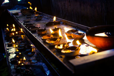 Lit diya on table at night