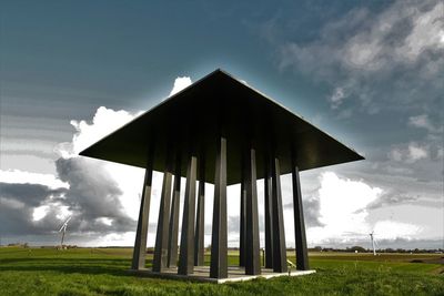 Low angle view of built structure on field against sky