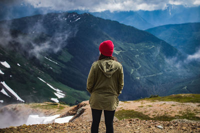 Rear view of man looking at mountains