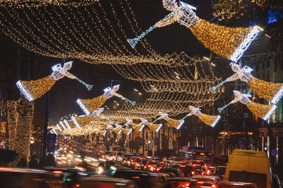 Low angle view of illuminated christmas lights at night