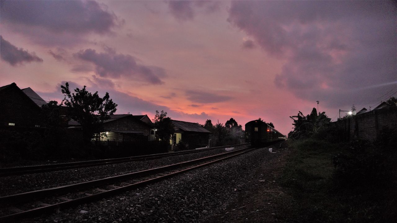 TRAIN AGAINST SKY AT SUNSET