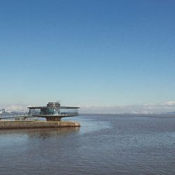 Scenic view of sea against clear blue sky