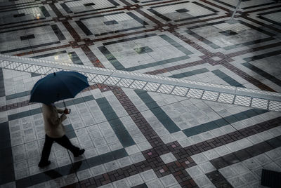 High angle view of woman standing on wet street