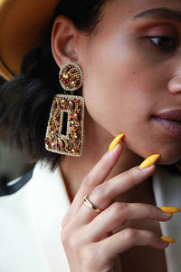 Close-up portrait of beautiful woman with hand