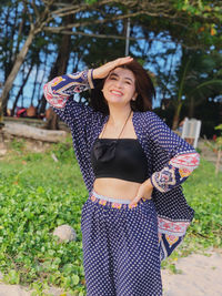 Portrait of smiling young woman standing outdoors