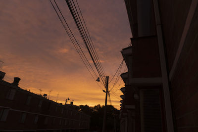 Low angle view of silhouette buildings against sky during sunset