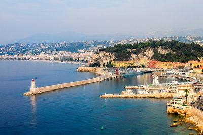 Scenic view of sea and cityscape against sky