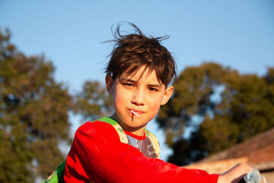 Portrait of boy eating lollipop outdoors