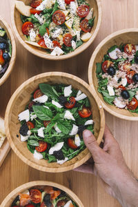 Top view of healthy takeaway salads in disposable eco-friendly paper containers
