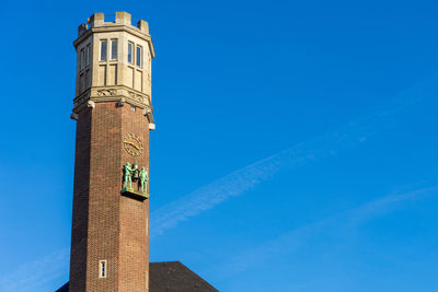 Low angle view of lighthouse against blue sky