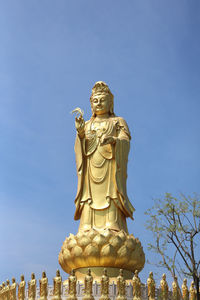 Low angle view of statue against sky