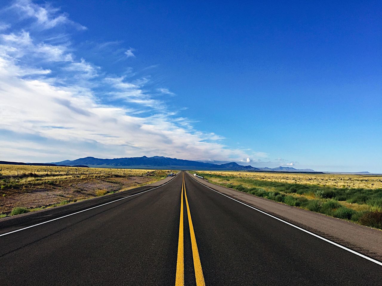 VIEW OF COUNTRY ROAD ALONG LANDSCAPE