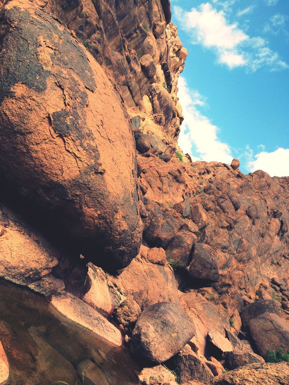 rock formation, rock - object, sky, tranquility, textured, geology, nature, low angle view, rough, rock, tranquil scene, eroded, scenics, beauty in nature, sunlight, physical geography, rocky, day, rocky mountains, cloud