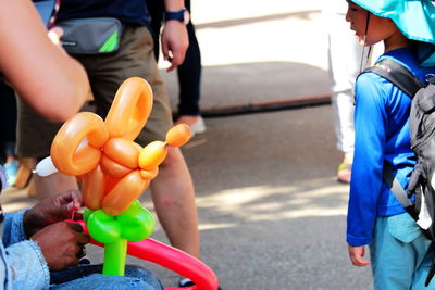 People holding umbrella on street