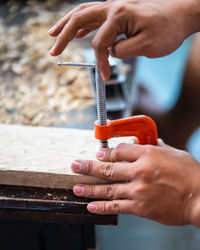 Midsection of man working on wood