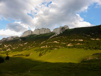 Scenic view of mountains against cloudy sky
