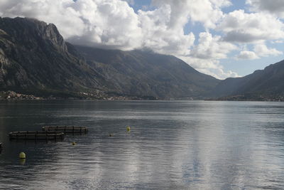 Scenic view of lake by mountains against sky