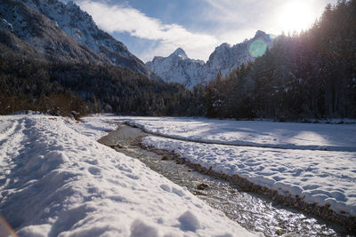 Scenic view of snow covered mountains against sky