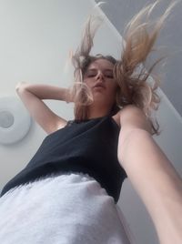 Beautiful young woman sitting at home