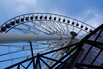 Low angle view of ferris wheel against sky