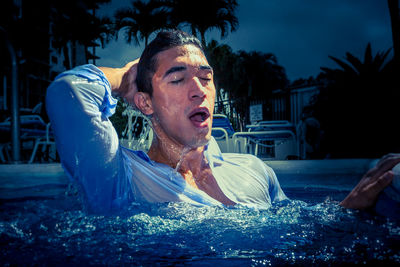 Portrait of man looking at swimming pool