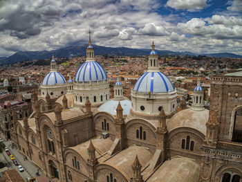 High angle view of buildings in city against cloudy sky