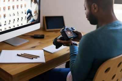 Young photographer editing images at desk