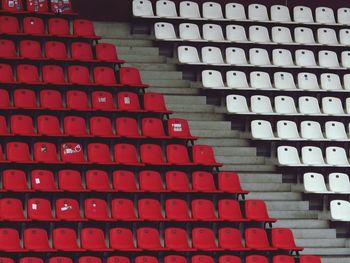 Low angle view of red and white empty chairs in stadium