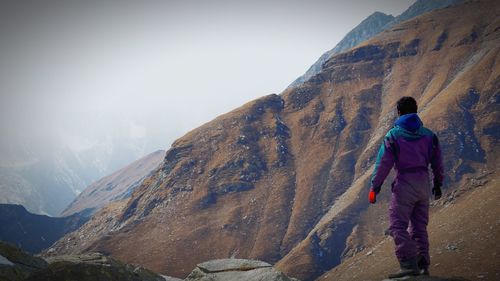 Full length of woman standing on cliff