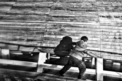 Full length of woman standing on bench