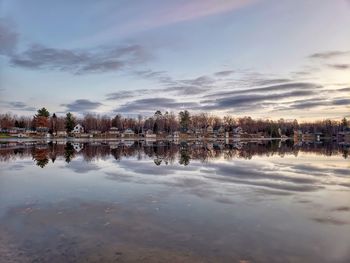 Scenic view of lake against sky at sunset