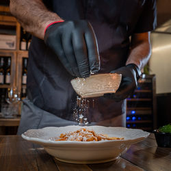 Midsection of man preparing food