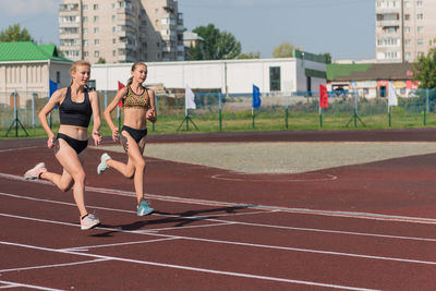 Full length of woman exercising on court