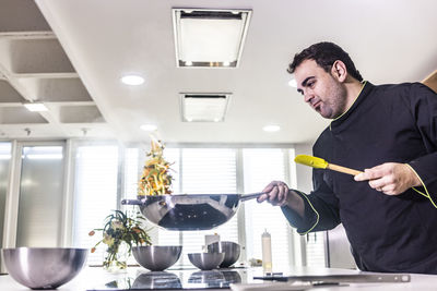  chef preparing food in kitchen at restaurant