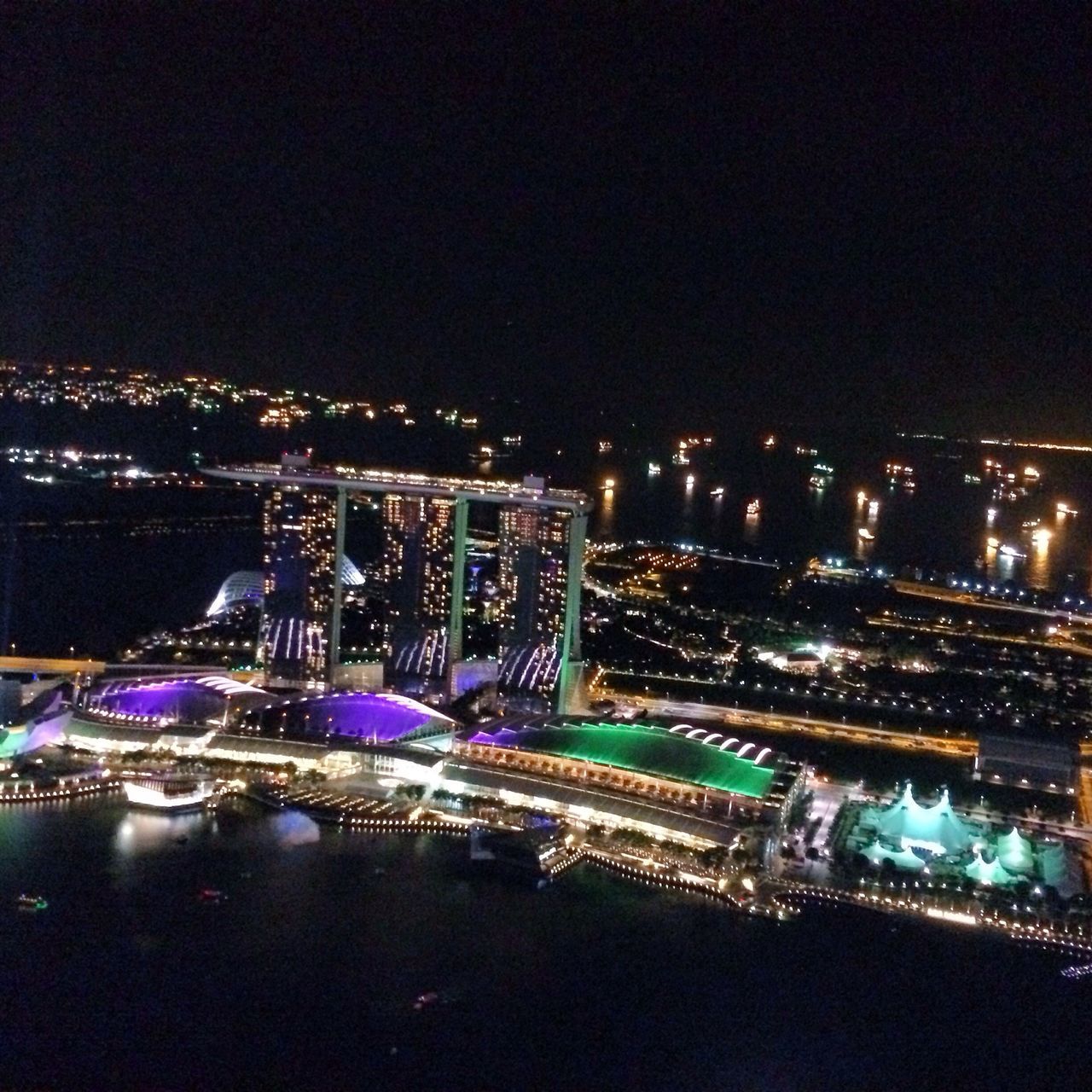 illuminated, night, building exterior, city, architecture, cityscape, built structure, high angle view, lighting equipment, city life, residential district, sky, residential building, light - natural phenomenon, dark, crowded, residential structure, glowing, outdoors, copy space