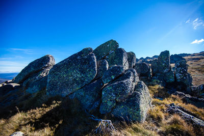 Low angle view of rock formations against sky