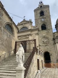 Low angle view of statue against building